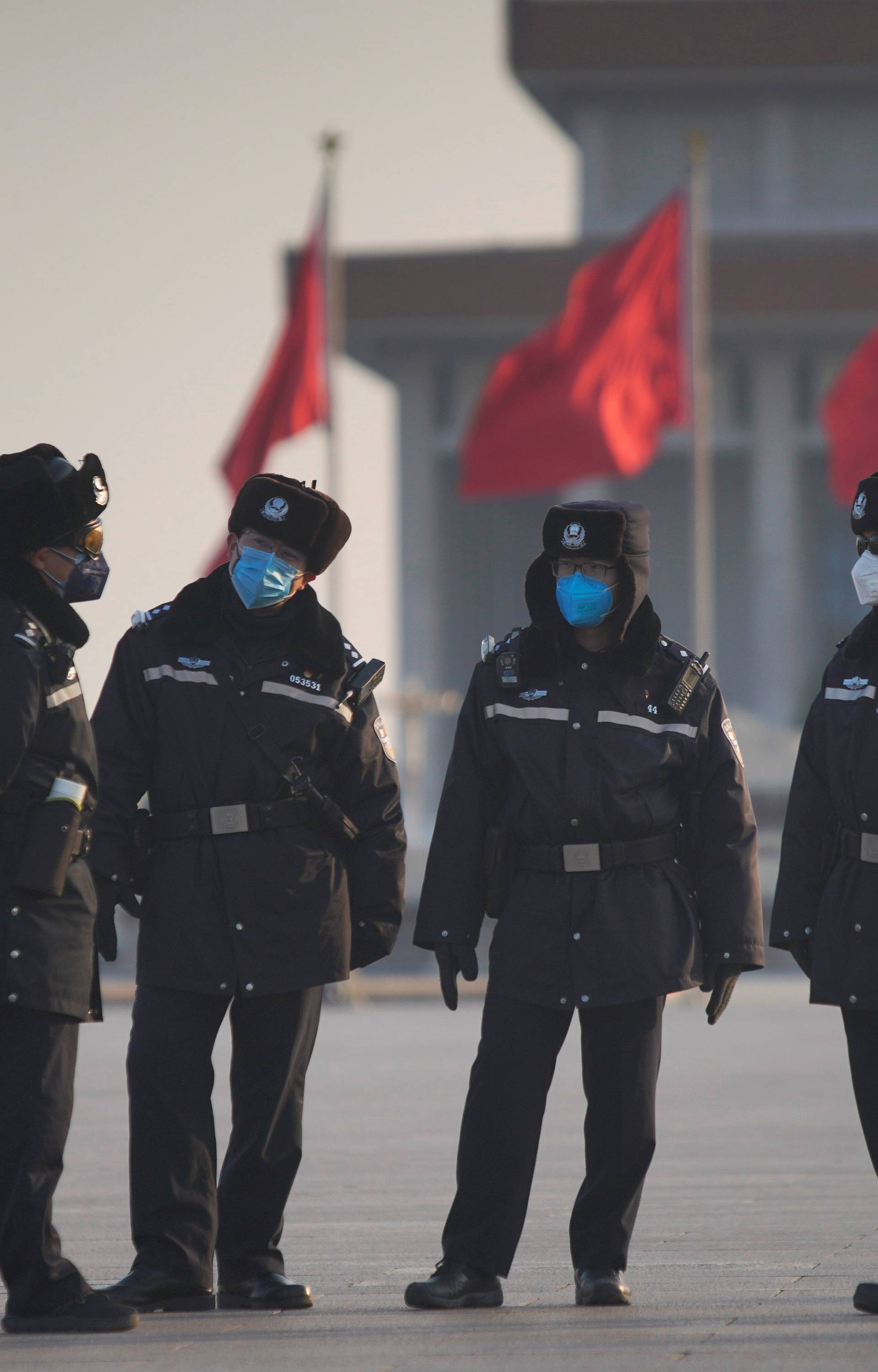 Police officers wearing masks are seen at at the Tiananmen Square, as the country is hit by an epidemic of the new coronavirus, in Beijing