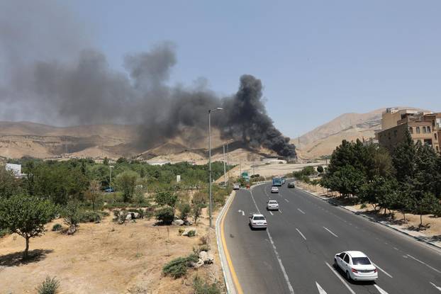 Smoke rises following what Iran says was an Israeli attack on Sharan Oil depot in Tehran