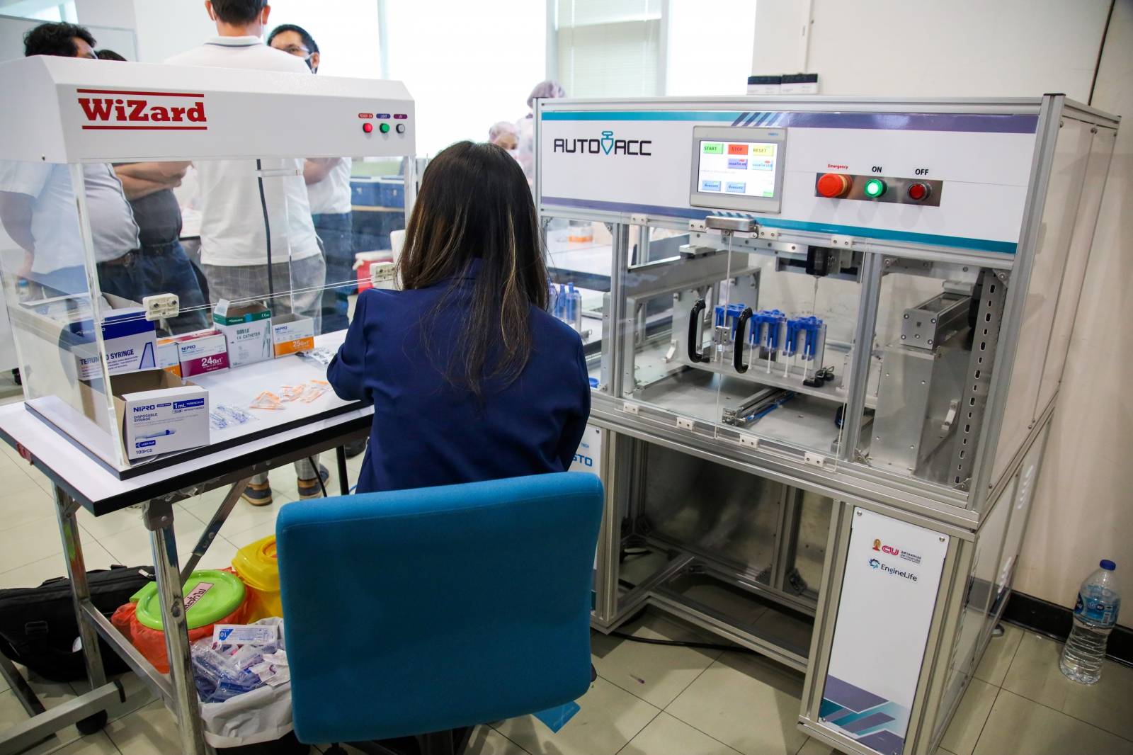 A technician works at AutoVacc vaccine extraction machine designed by the Chulalongkorn University's Biomedical Engineering Research Center to extract extra doses out of AstraZeneca vaccine vials in Bangkok