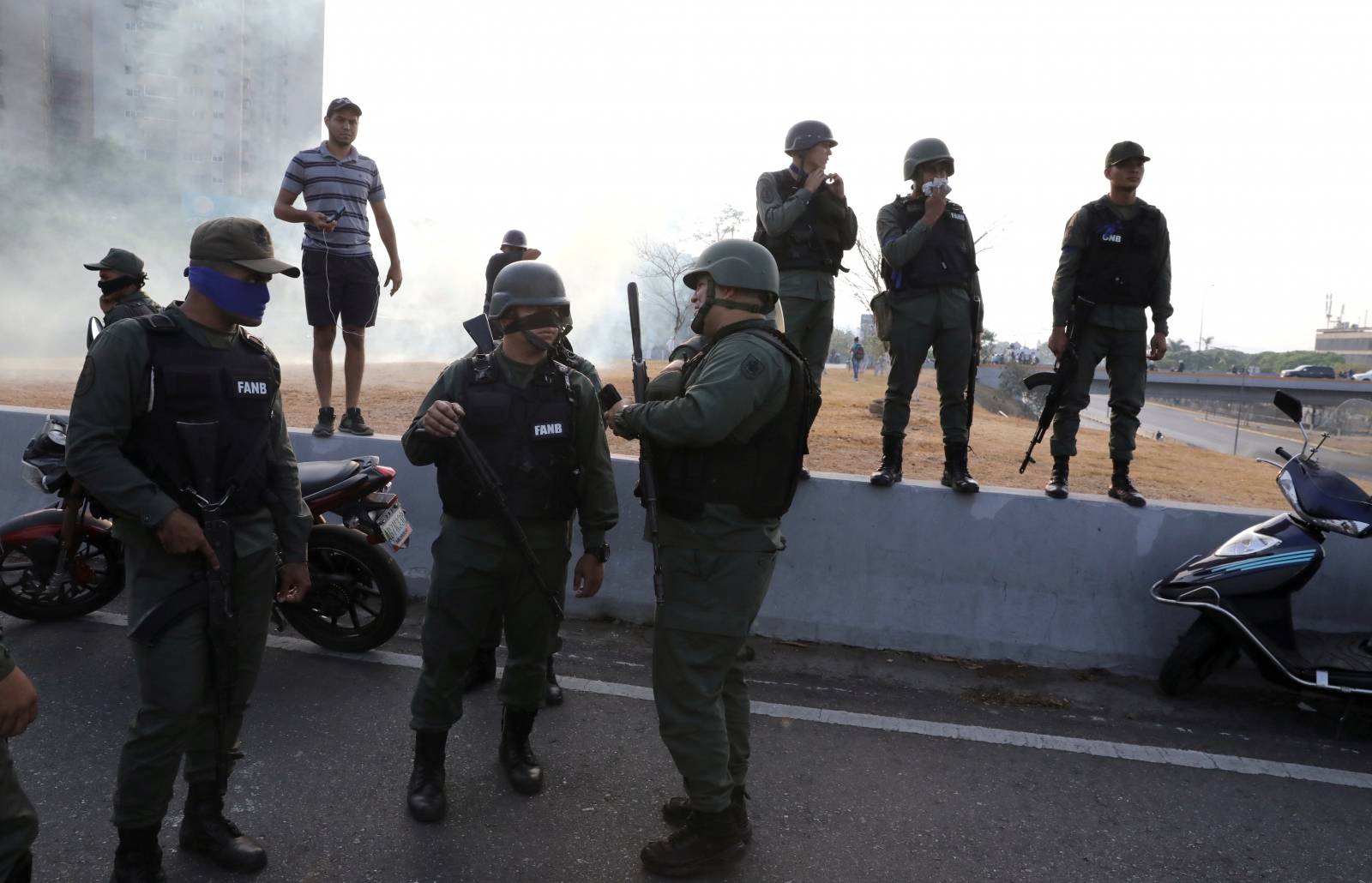 Military members stand near the Generalisimo Francisco de Miranda Airbase in Caracas