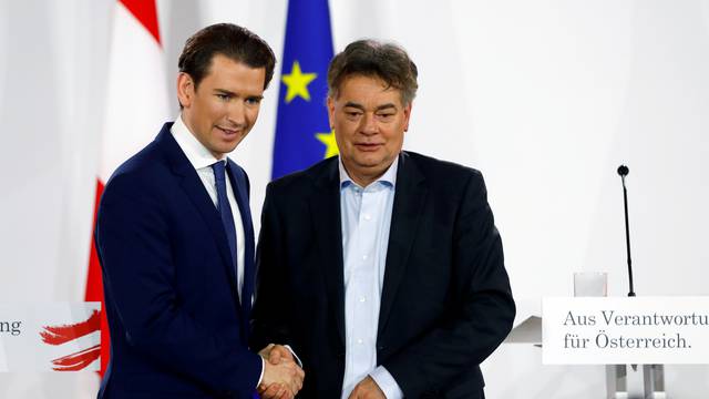 FILE PHOTO: Head of Austria's Green Party Werner Kogler and head of People's Party (OeVP) Sebastian Kurz shake hands after delivering a statement in Vienna