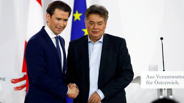 FILE PHOTO: Head of Austria's Green Party Werner Kogler and head of People's Party (OeVP) Sebastian Kurz shake hands after delivering a statement in Vienna