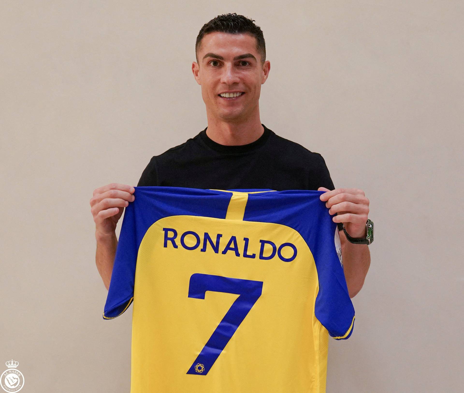 Portuguese soccer player Cristiano Ronaldo holds a shirt of the Saudi club Al-Nassr after signing the contract, in Madrid