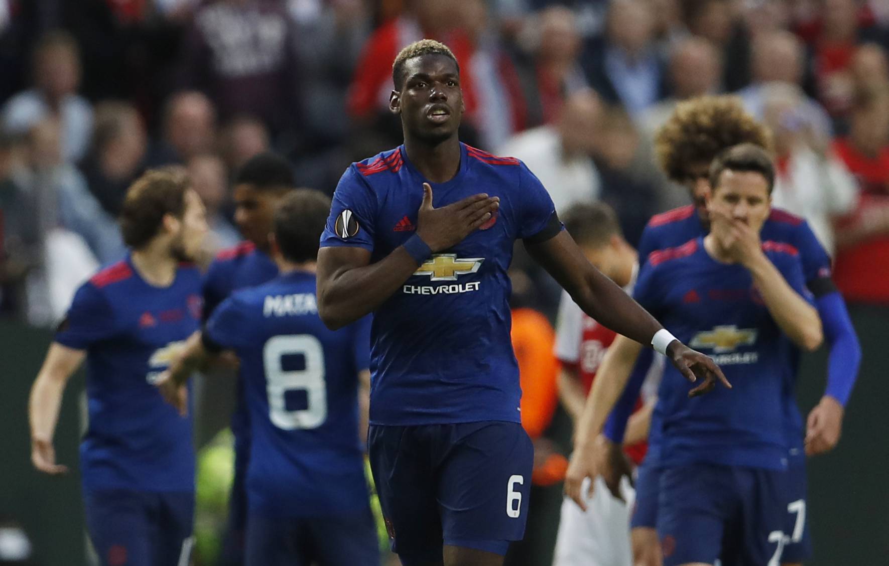 Manchester United's Paul Pogba celebrates scoring their first goal with team mates