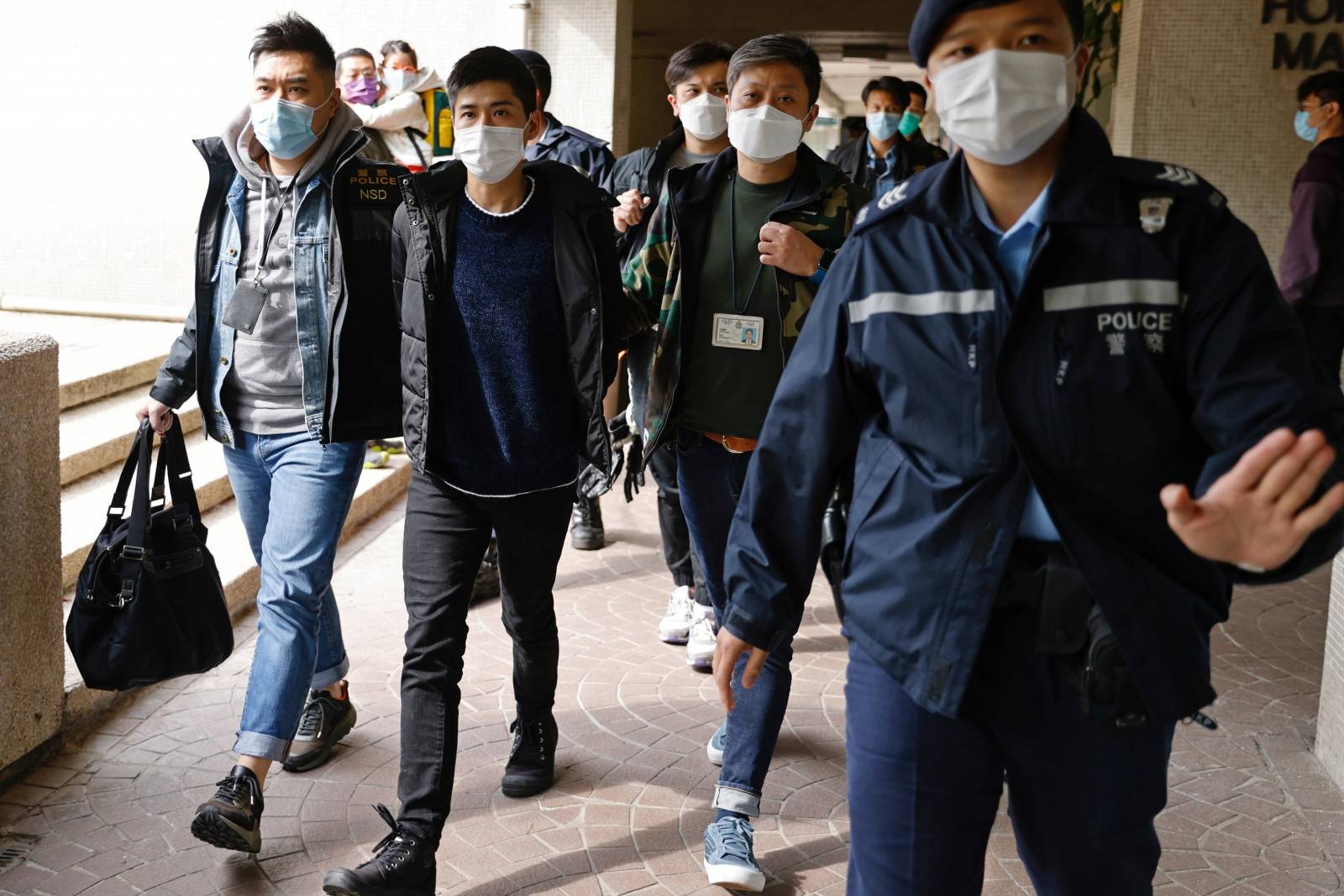 Pro-democracy activist Lester Shum is taken away by police officers in Hong Kong