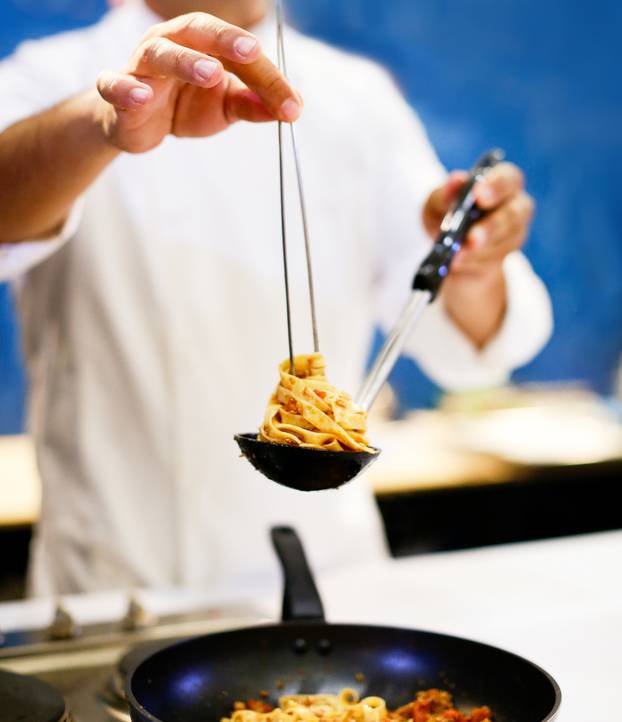 Chef cooking pasta, Chef serves spaghetti carbonara on the plate