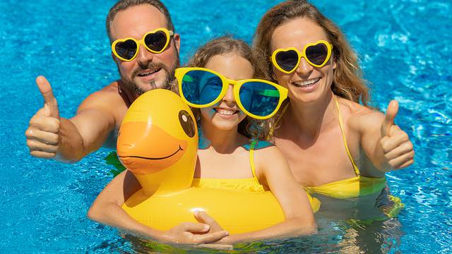 Happy Family In Outdoor Pool