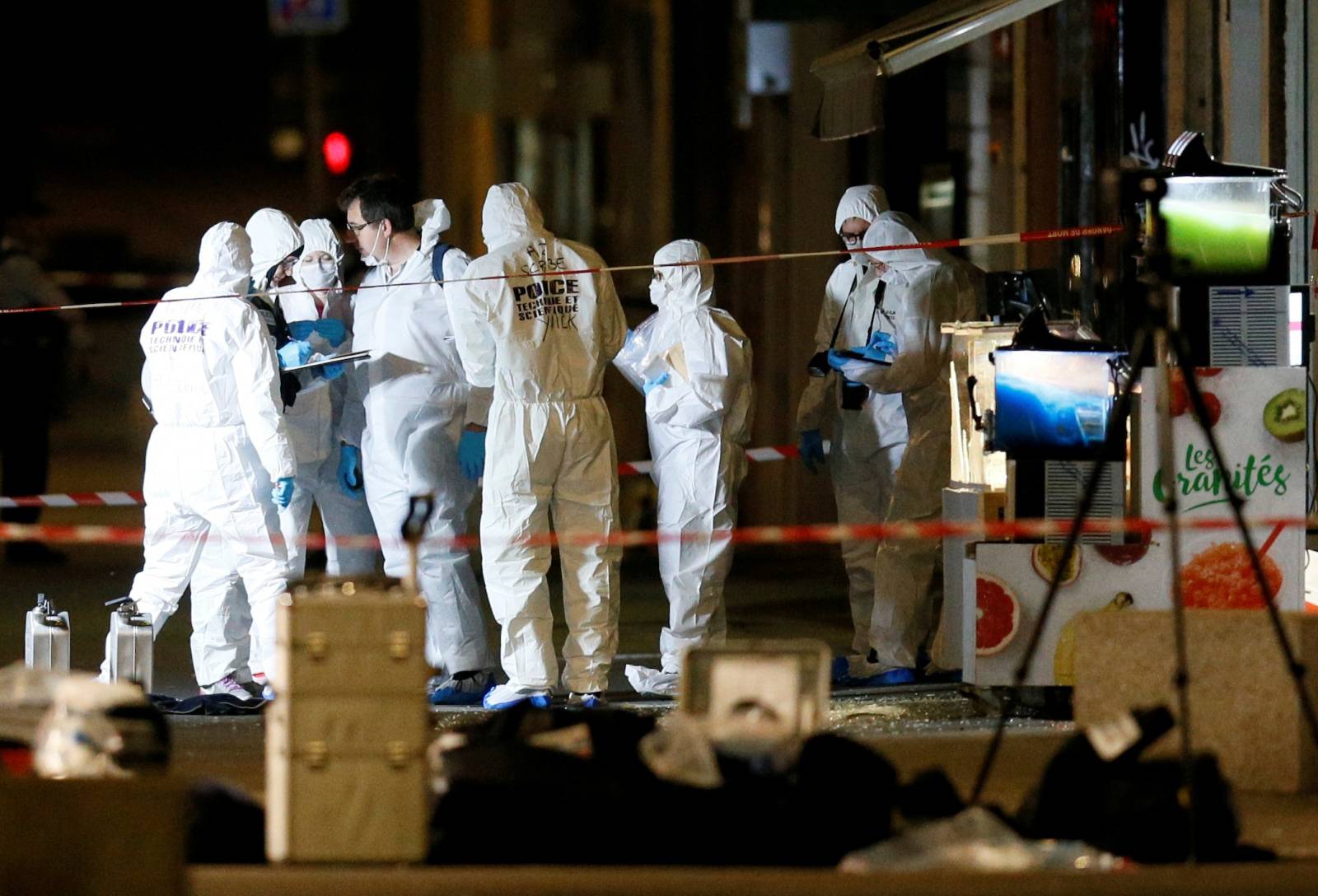 Forensic officers inspect the site of a suspected bomb attack in central Lyon