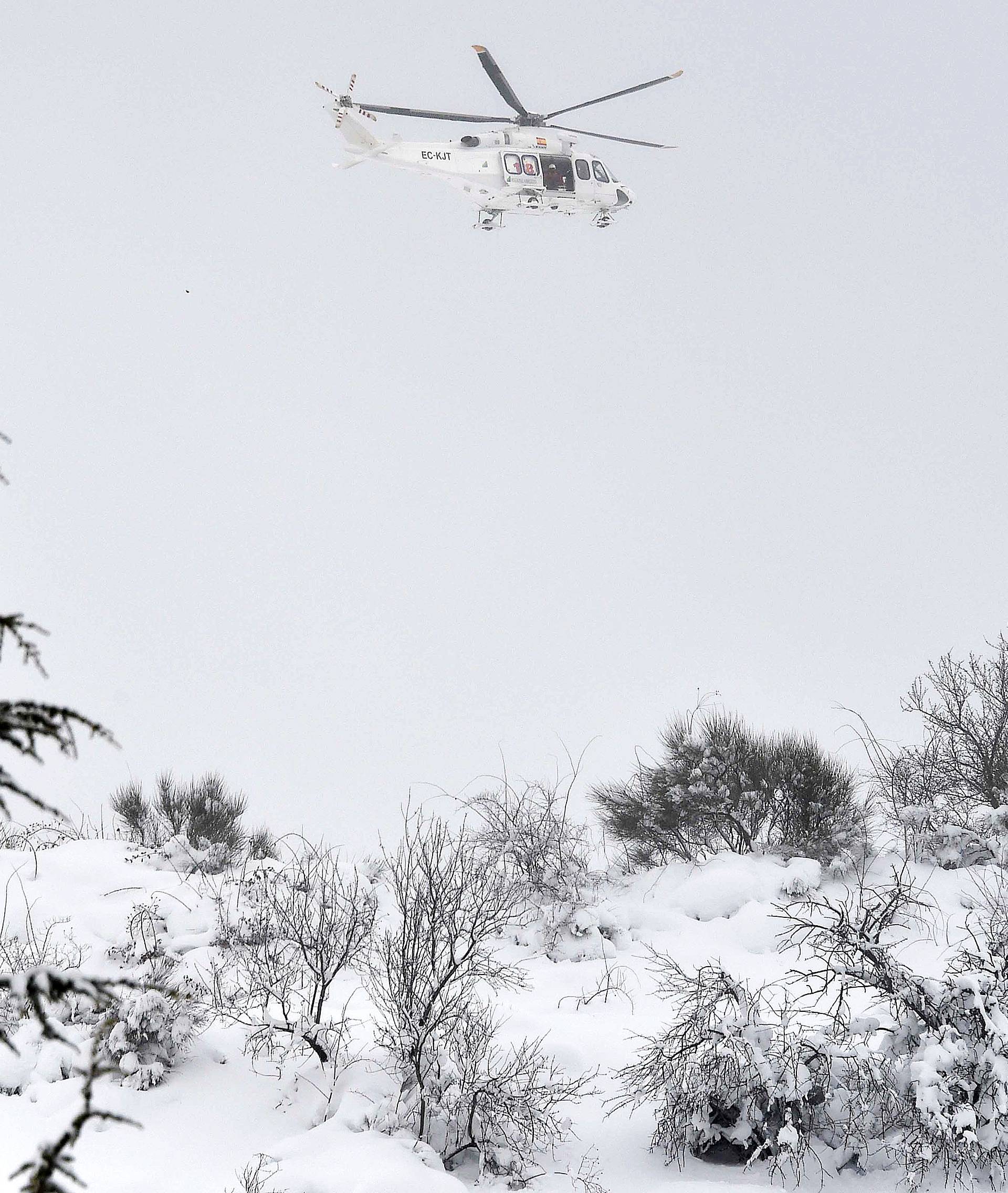 An Alpine Rescue helicopter is seen next the town of Assergi