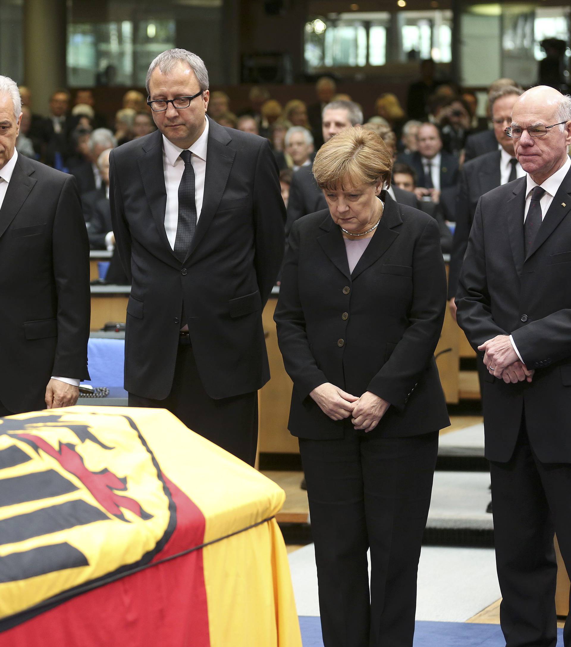 German officials pay respects during a memorial service for former West German foreign minister Genscher in the former lower house of parliament Bundestag in Bonn