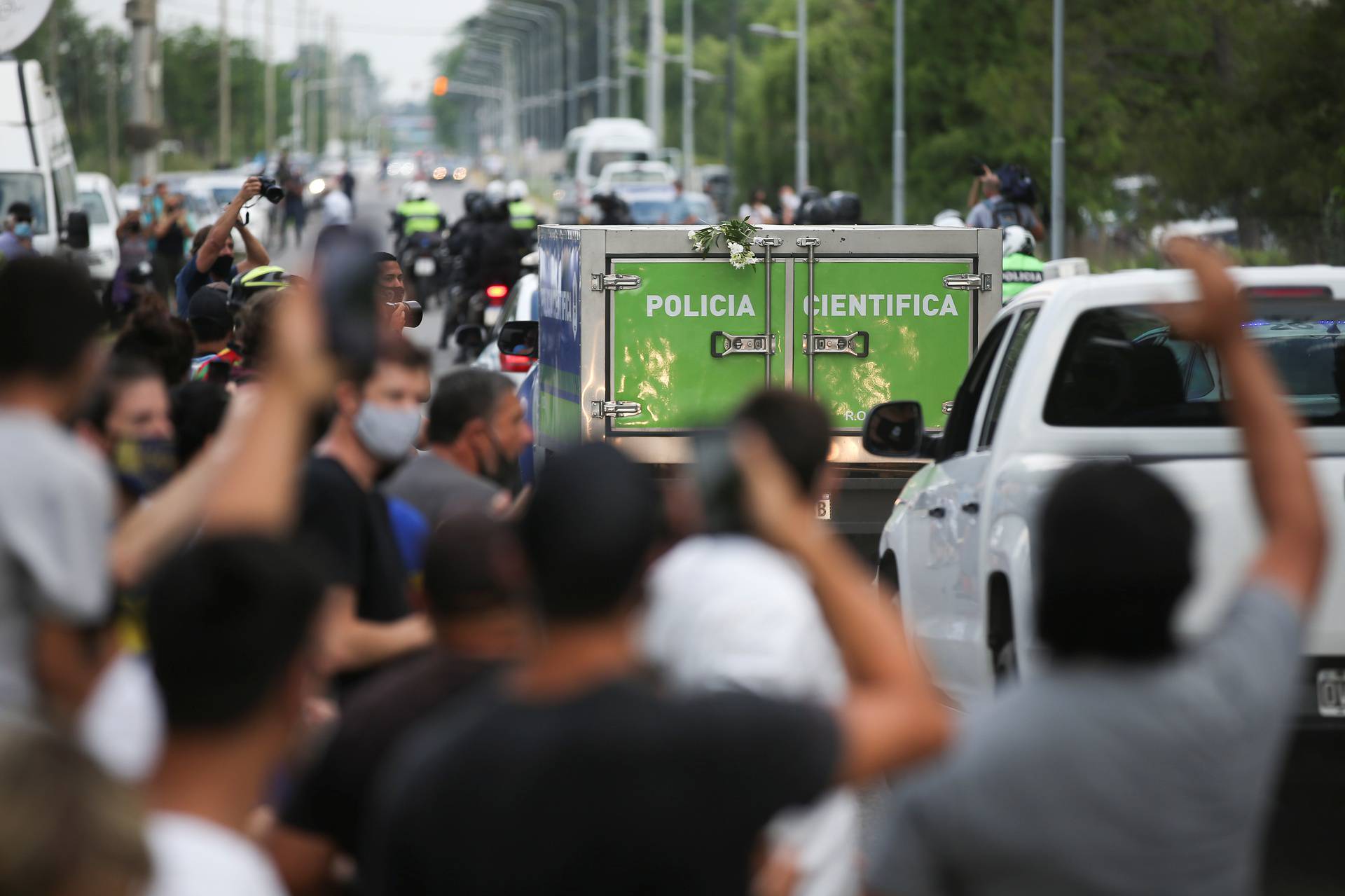 A scientific police vehicle carrying the body of Argentine great Diego Maradona leaves the house where he was staying