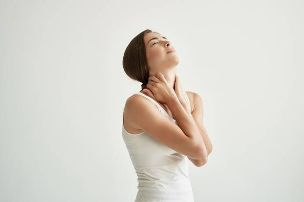 woman in white t-shirt joint pain health problems discomfort