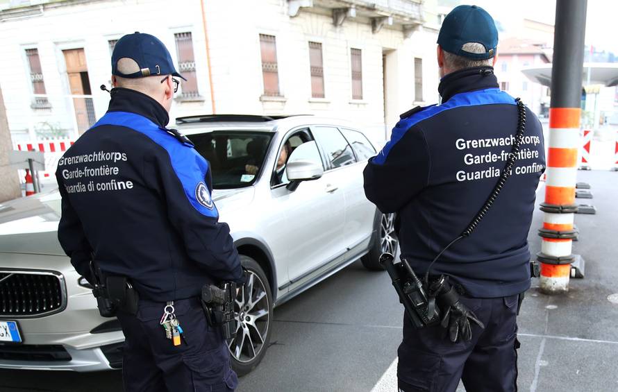 A car passes by as Swiss custom officers control the Swiss-Italian border during the outbreak of the coronavirus disease (COVID-19) in Chiasso
