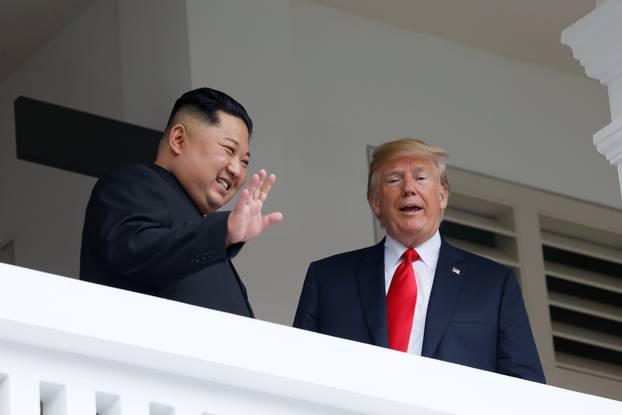 U.S. President Donald Trump talks with North Korean leader Kim Jong Un at the Capella Hotel on Sentosa island in Singapore