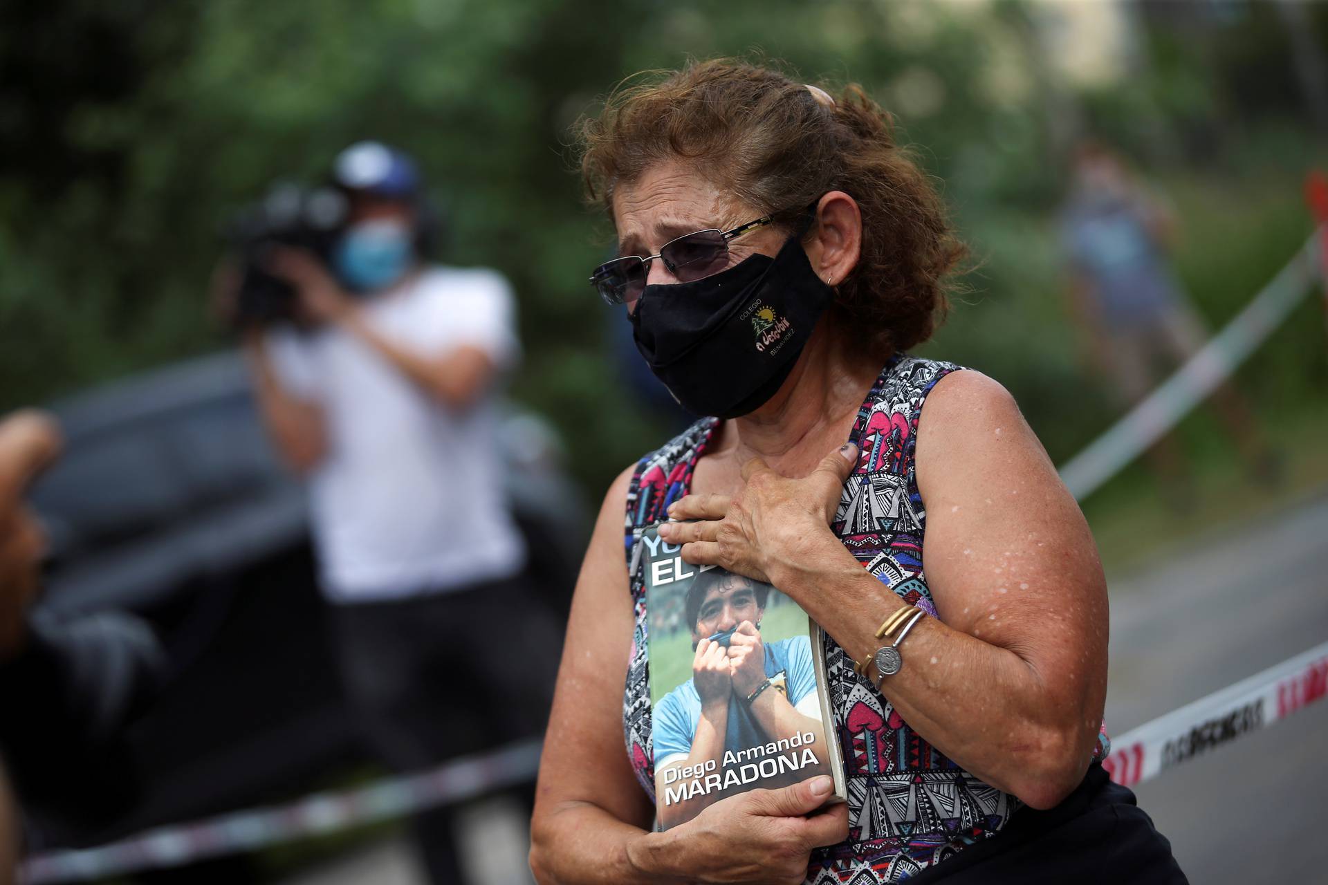 Woman reacts outside the house where Diego Maradona was staying, in Tigre