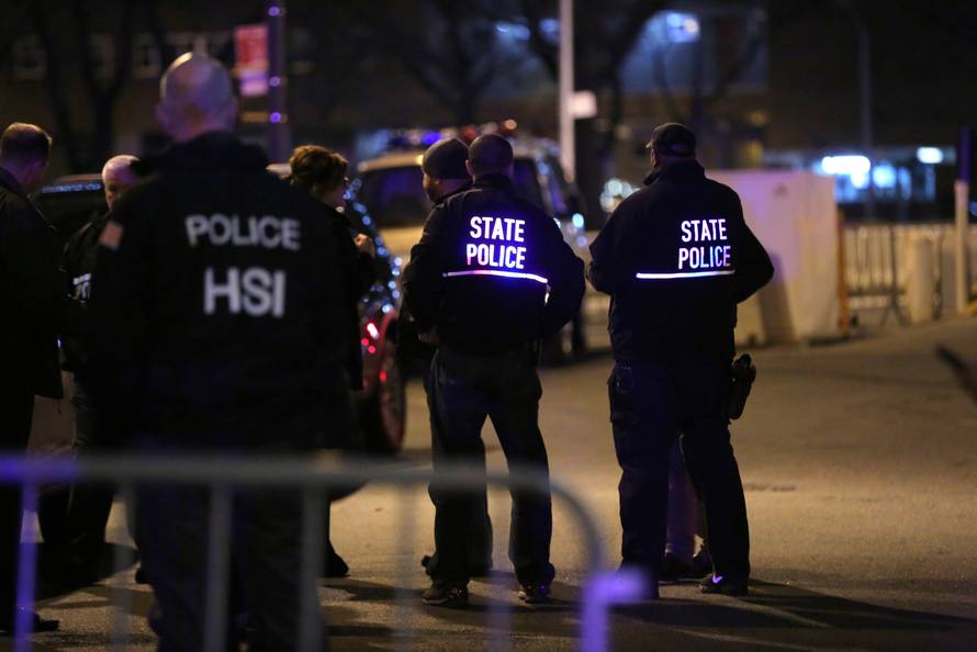 Law enforcement agents assist a motorcade believed to be transporting Joaquin "El Chapo" Guzman at the Manhattan Detention Complex in the Manhattan borough of New York City, New York, U.S.