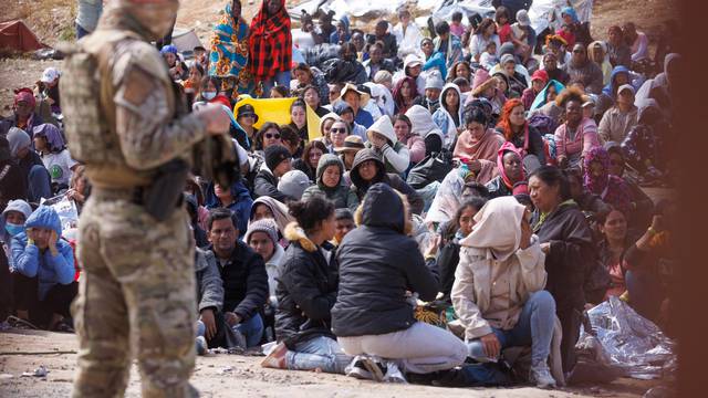 Migrants gather along the U.S. Mexico border near San Diego before the lifting of Tile 42