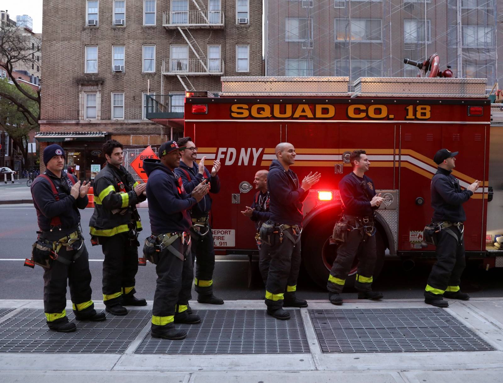 Firefighters and members of the public thank medical workers at 7PM during the outbreak of the coronavirus disease (COVID-19) in New York