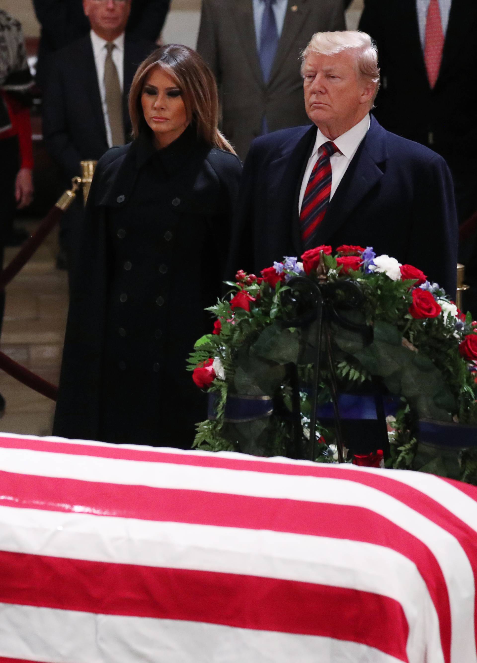 President Donald Trump and First Lady Melania Trump pay their respects at the casket of former U.S. President George H.W. Bush in Capitol Rotunda in Washington