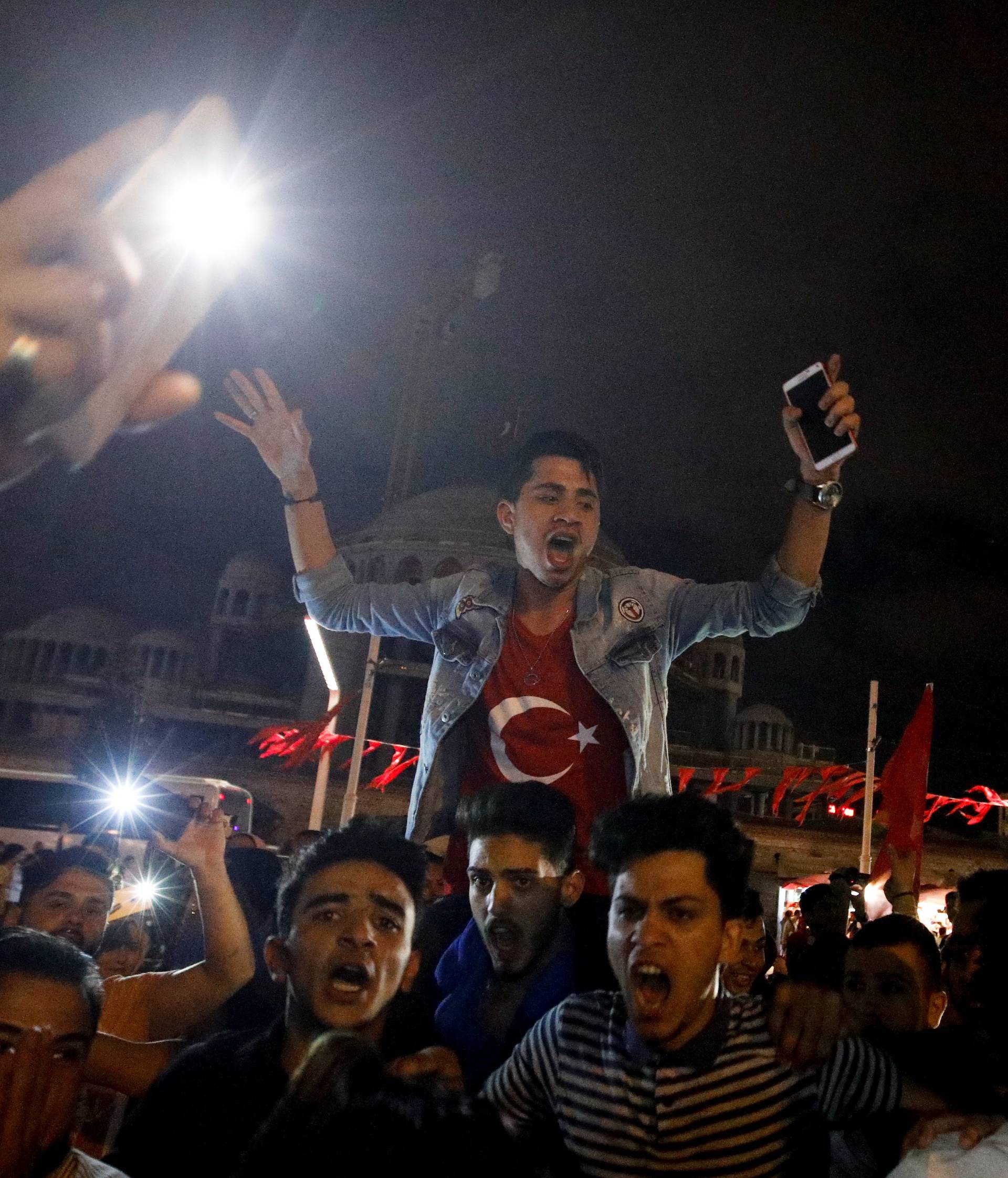 Supporters of Turkish President Tayyip Erdogan celebrate at Taksim square in Istanbul