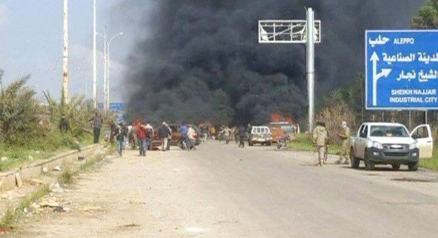 Still image shows a cloud of black smoke rising from vehicles in the distance in what is said to be Aleppo's outskirts
