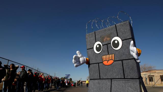 A Trump supporter dressed up as a border wall is seen as others queue to enter El Paso County Coliseum for a rally by U.S. President Trump in El Paso