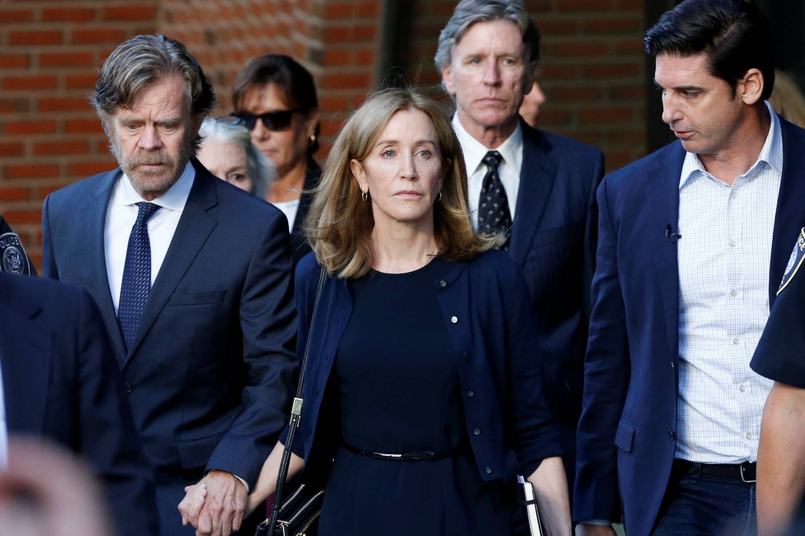 Actress Felicity Huffman and husband William H. Macy leave the federal courthouse in Boston