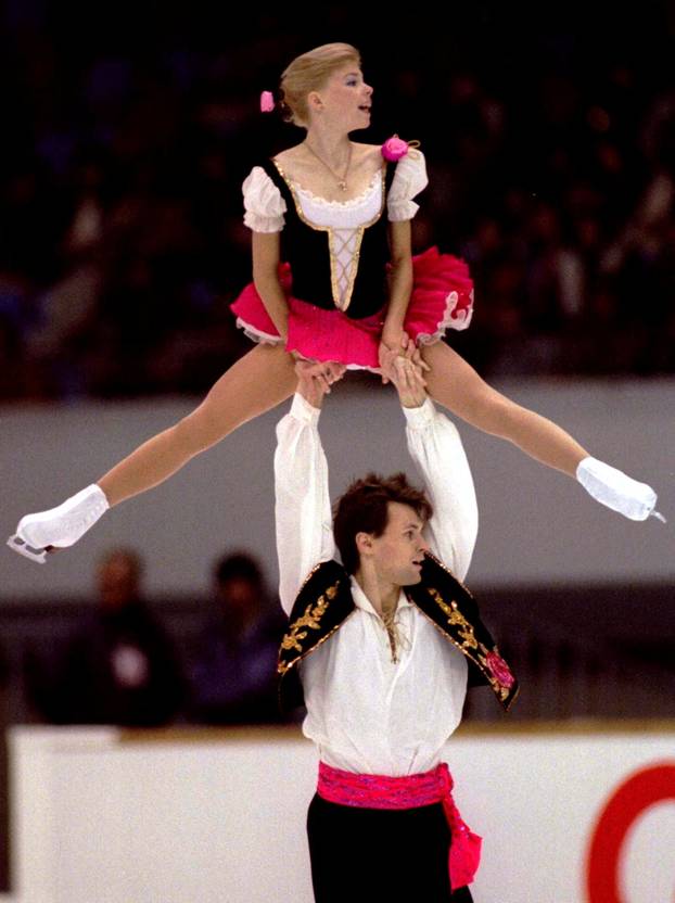 FILE PHOTO: Russia's Vadim Naumov lifts up his partner Evgenia Shishkova during the free skating to win the pairs event of the NHK Trophy figure skating grand prix in Nagoya