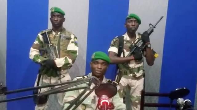 A still image taken from a video shows military officers giving a statement from a radio station in Libreville