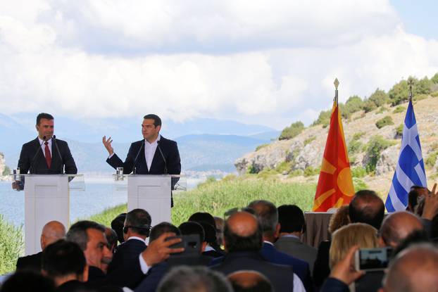 Greek Prime Minister Alexis Tsipras and Macedonian Prime Minister Zoran Zaev speak before the signing of an accord to settle a long dispute over the former Yugoslav republic