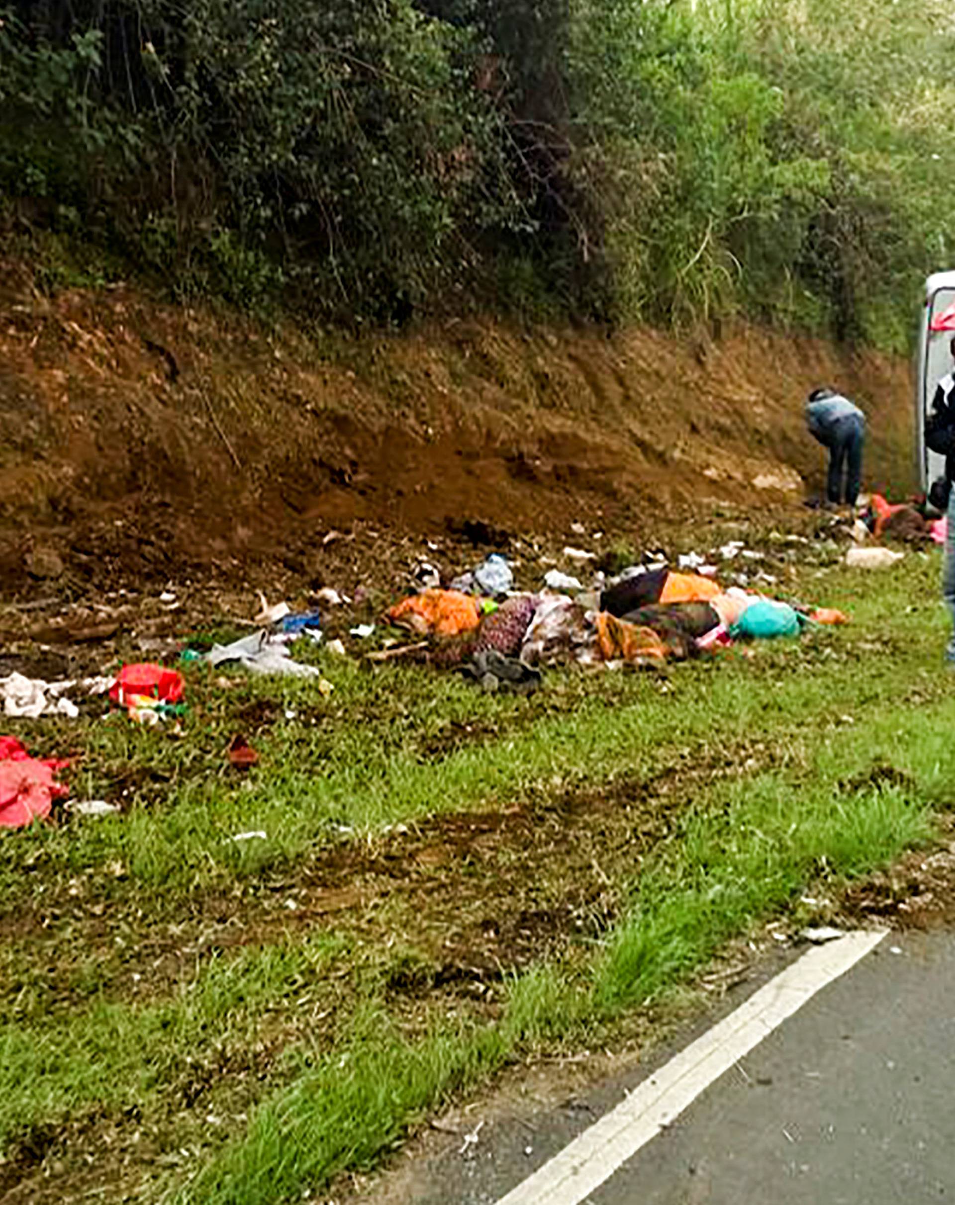 People examine the site of fatal tourist bus accident in Subang Regency