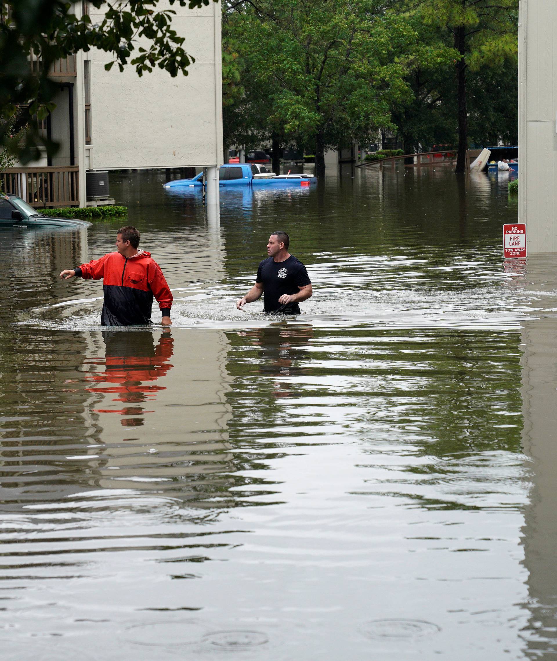 Men look for people wanting to be evacuated from the Hurricane Harvey floodwaters in Dickinson