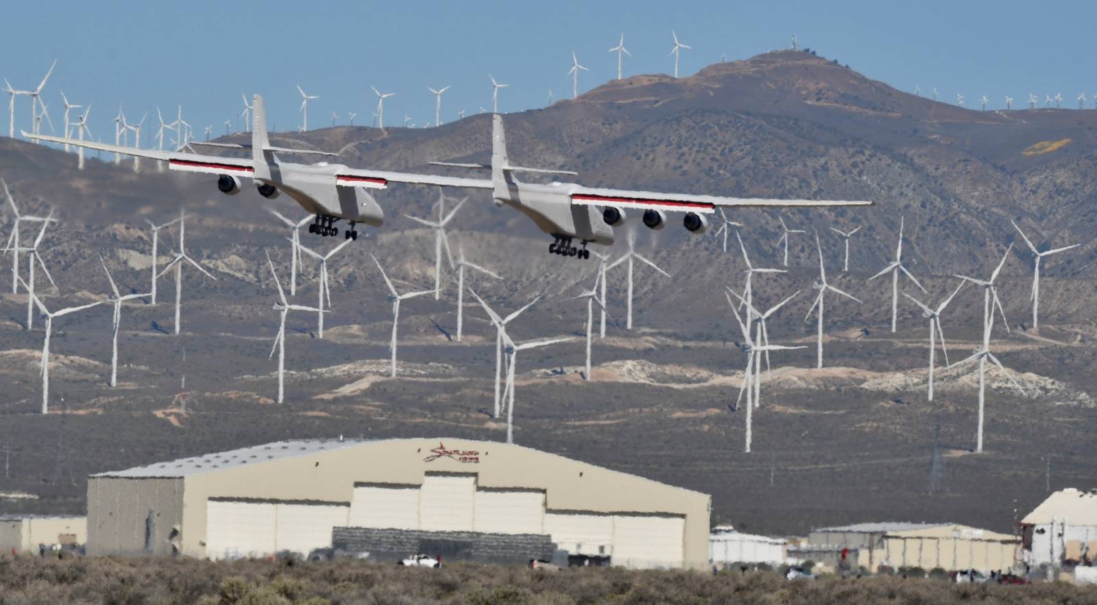 The world's largest airplane, built by the late Paul Allen's company Stratolaunch Systems, lands during its first test flight in Mojave