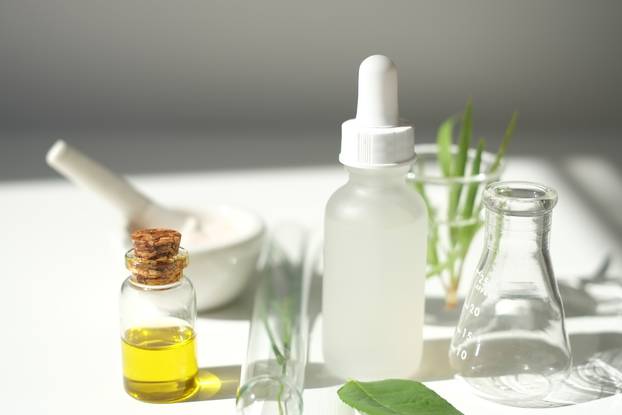 the scientist,dermatologist testing the organic natural product in the laboratory.research and development beauty skincare concept.blank package,bottle,container .cream,serum.