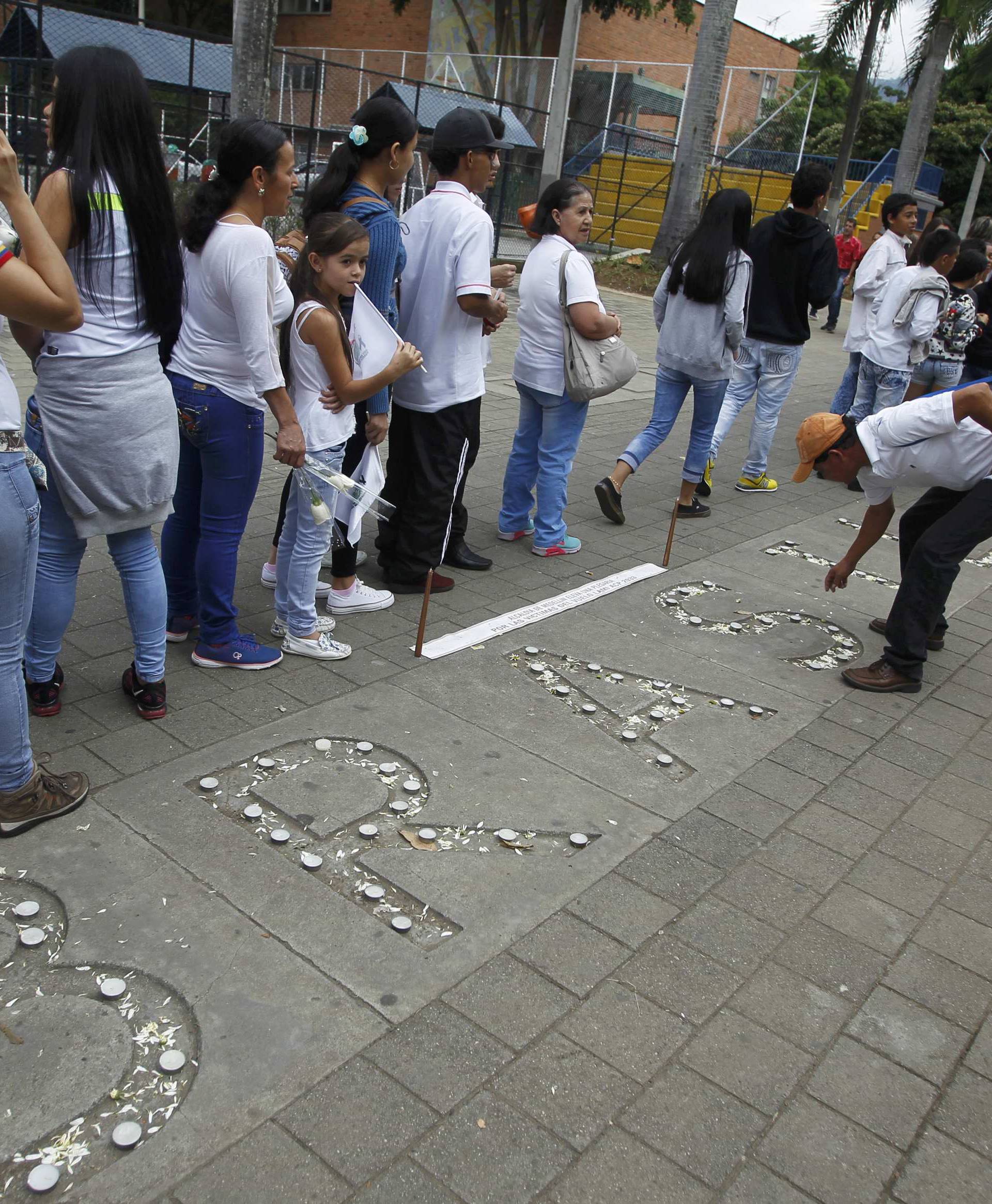 Fans of Atletico Nacional soccer club pay tribute to the players of Brazilian club Chapecoense killed in the recent airplane crash in Medellin