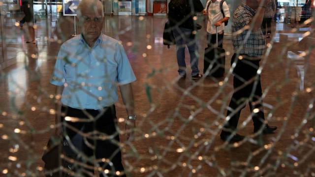 A man looks at a broken glass at Istanbul Ataturk airport