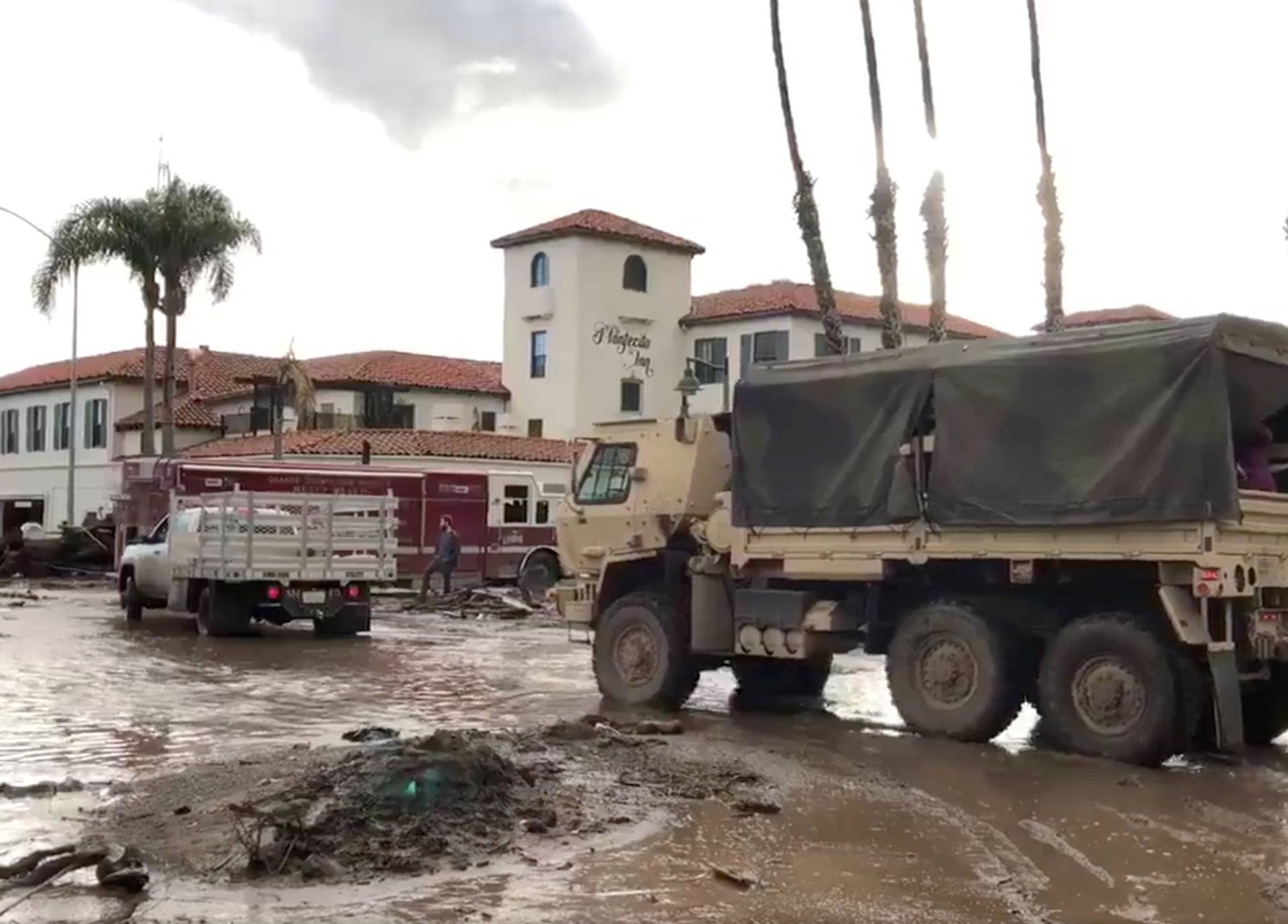 Military vehicles arrive to assist evacuation operations at an area damaged by mudslides in Montecito, California, U.S.