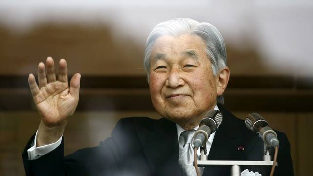 Japan's Emperor Akihito's waves to well-wishers at the Imperial Palace in Tokyo
