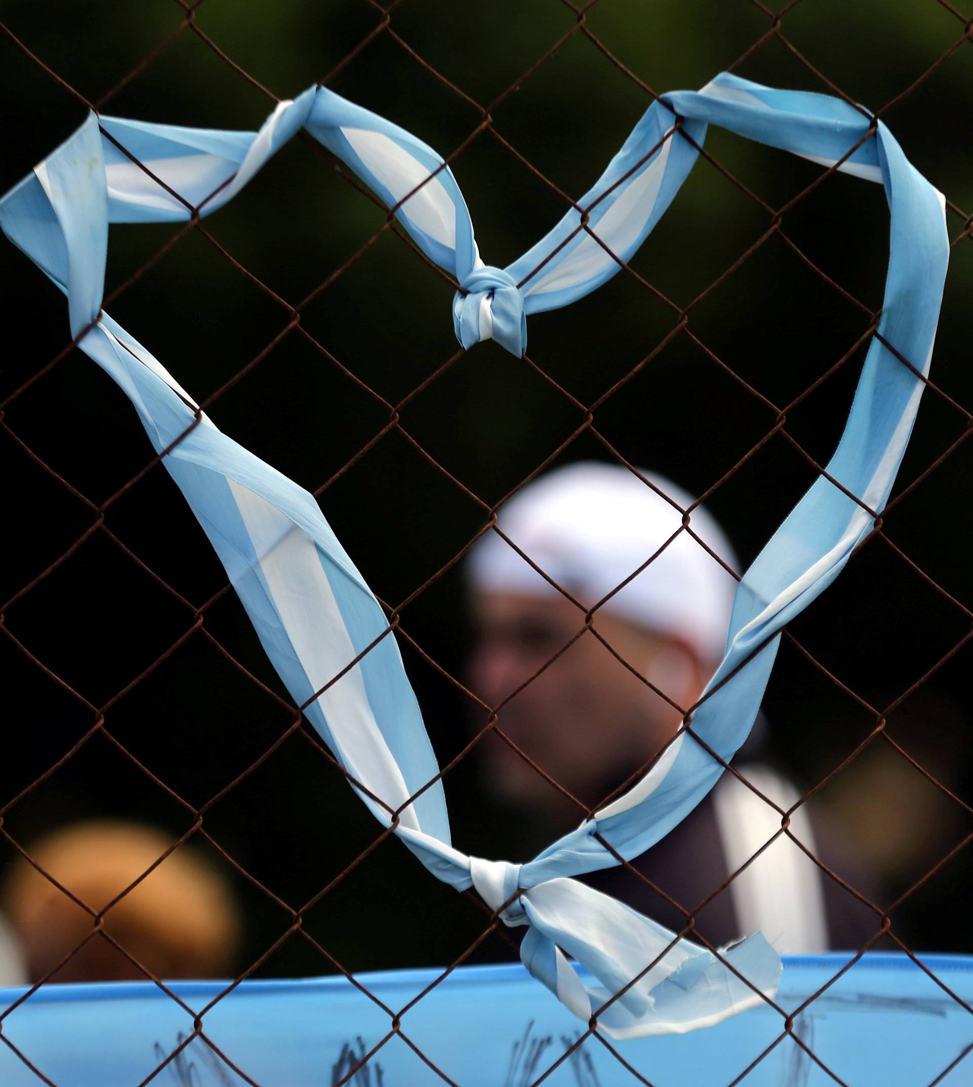 A heart formed with stripes with the colours of Argentina's national flag hangs from a fence outside the Argentine Naval Base in Mar del Plata