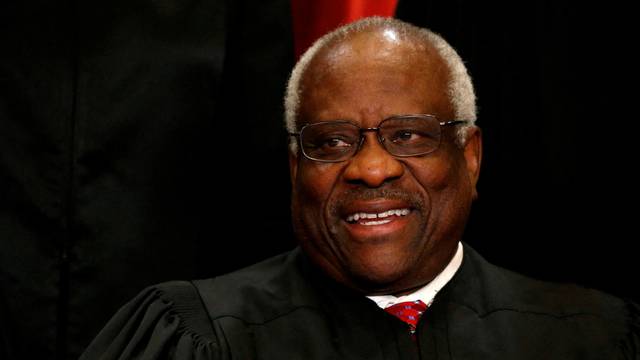 FILE PHOTO: Justice Clarence Thomas participates in taking a new family photo with fellow justices at the Supreme Court building in Washington