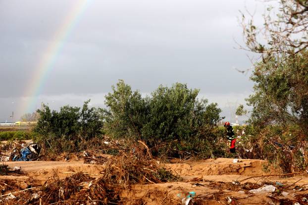 Members of the military search for bodies of people missing after heavy rains, in Quart de Poblet