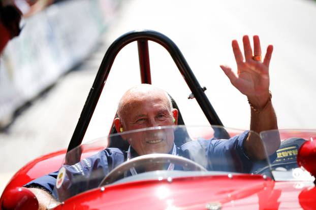 FILE PHOTO: Stirling Moss waves to spectators as he sits in his 1955 Ferrari 750 Monza during the Ennstal Classic rally in this 2013 file photo