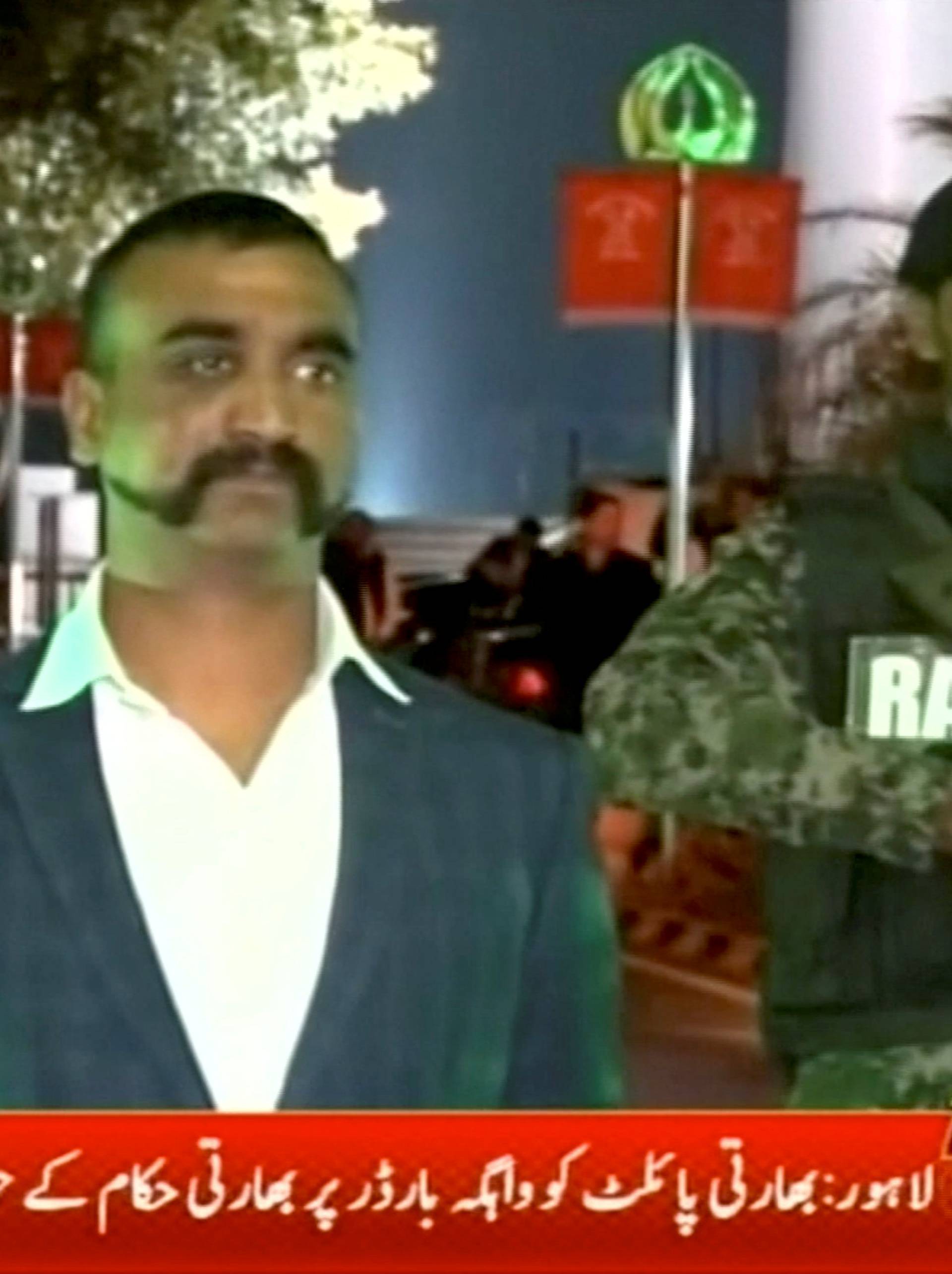 Indian pilot, Wing Commander Abhinandan, stands under armed escort near Pakistan-India border in Wagah