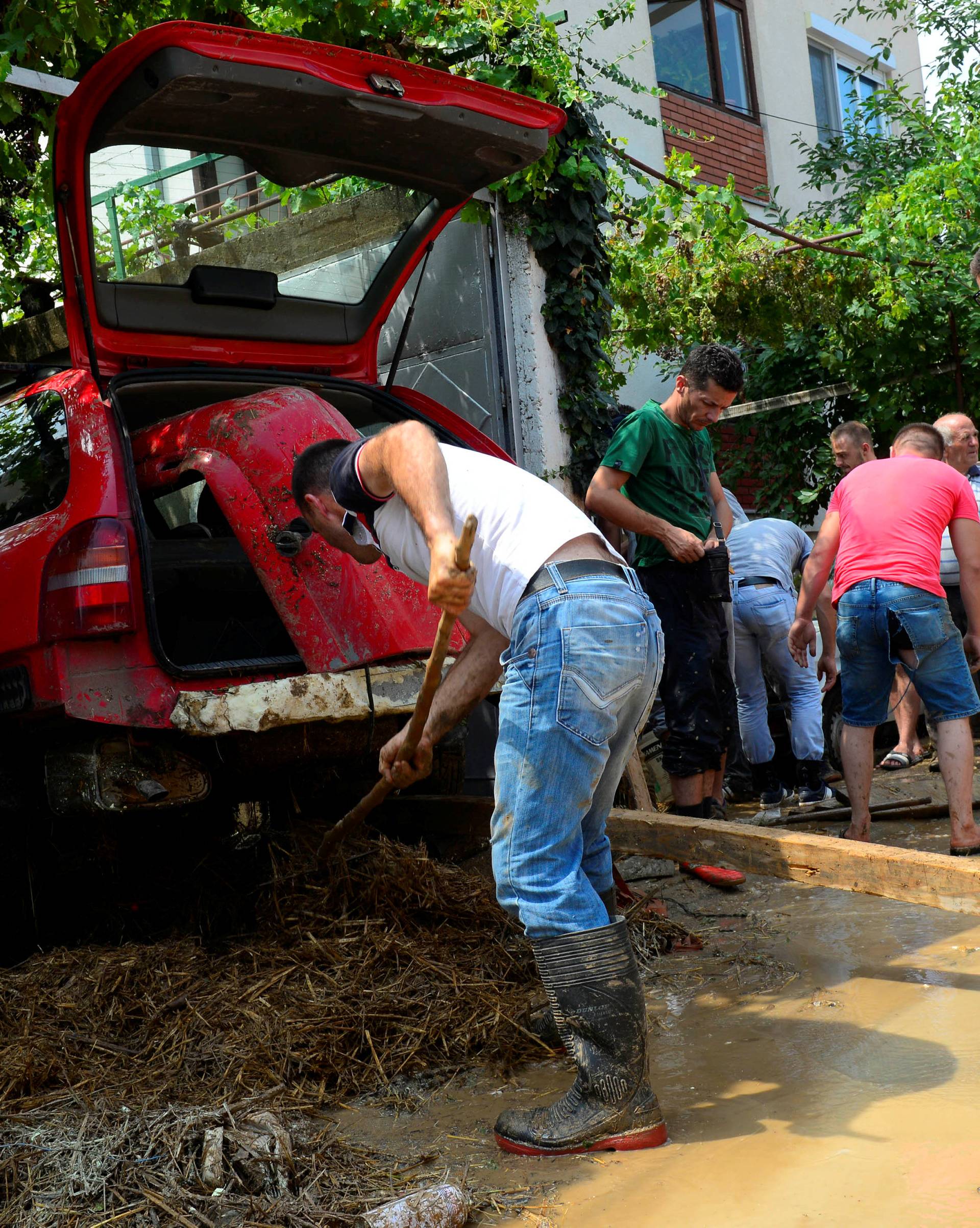 People clean up after heavy floods in Cento