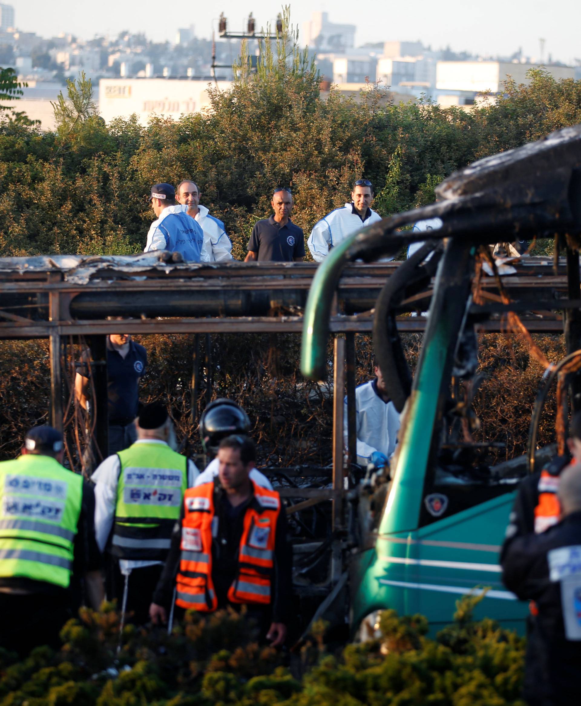 Emergency workers search the scene after a blast on a bus in Jerusalem