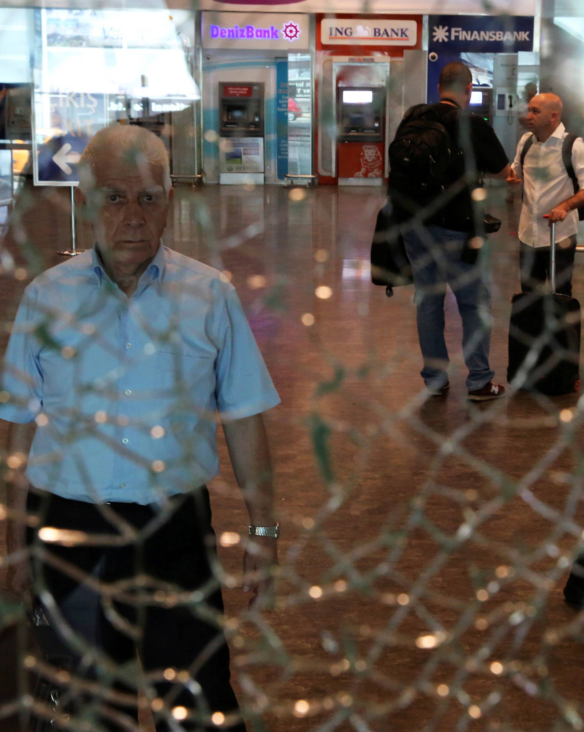 A man looks at a broken glass at Istanbul Ataturk airport