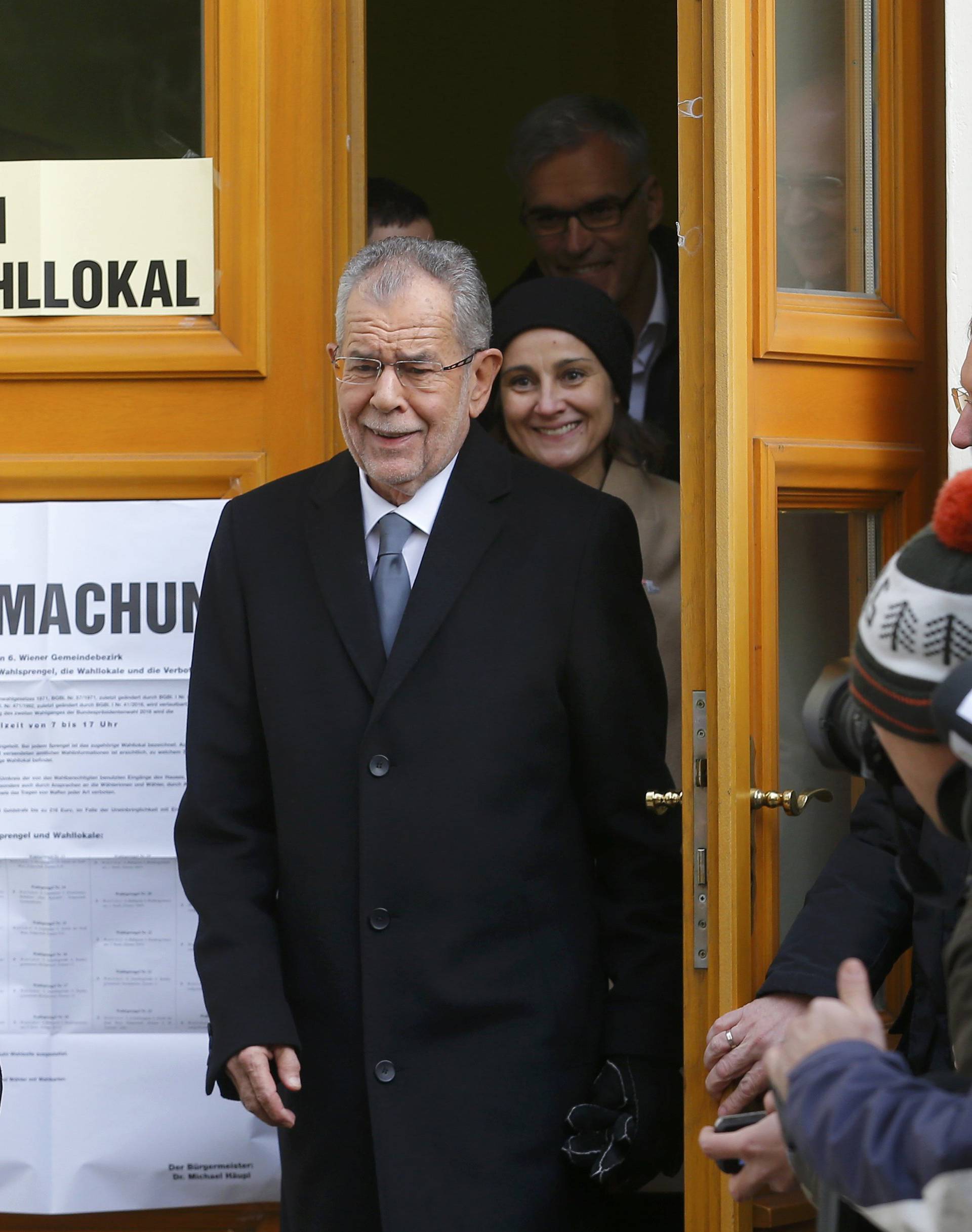 Austrian presidential candidate Van der Bellen, who is supported by the Greens, and his wife Schmidauer leave polling station in Vienna