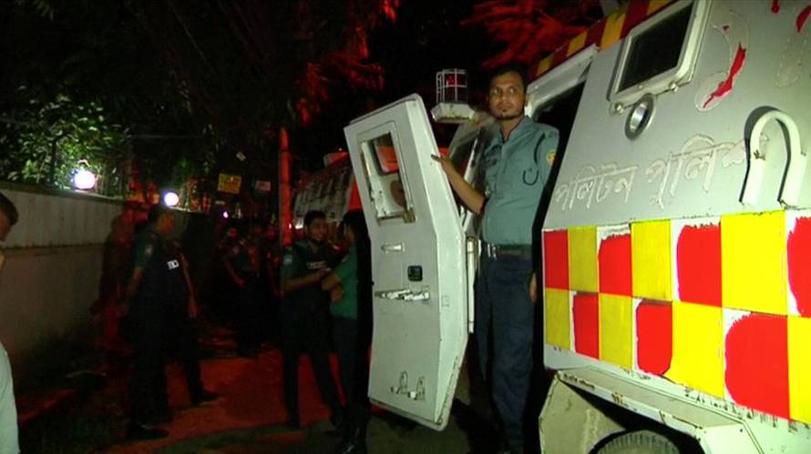 A policeman stands at the entrance to a riot vehicle outside the Holey Artisan restaurant, where gunmen had taken hostages, in the upscale Gulshan area of Dhaka, Bangladesh