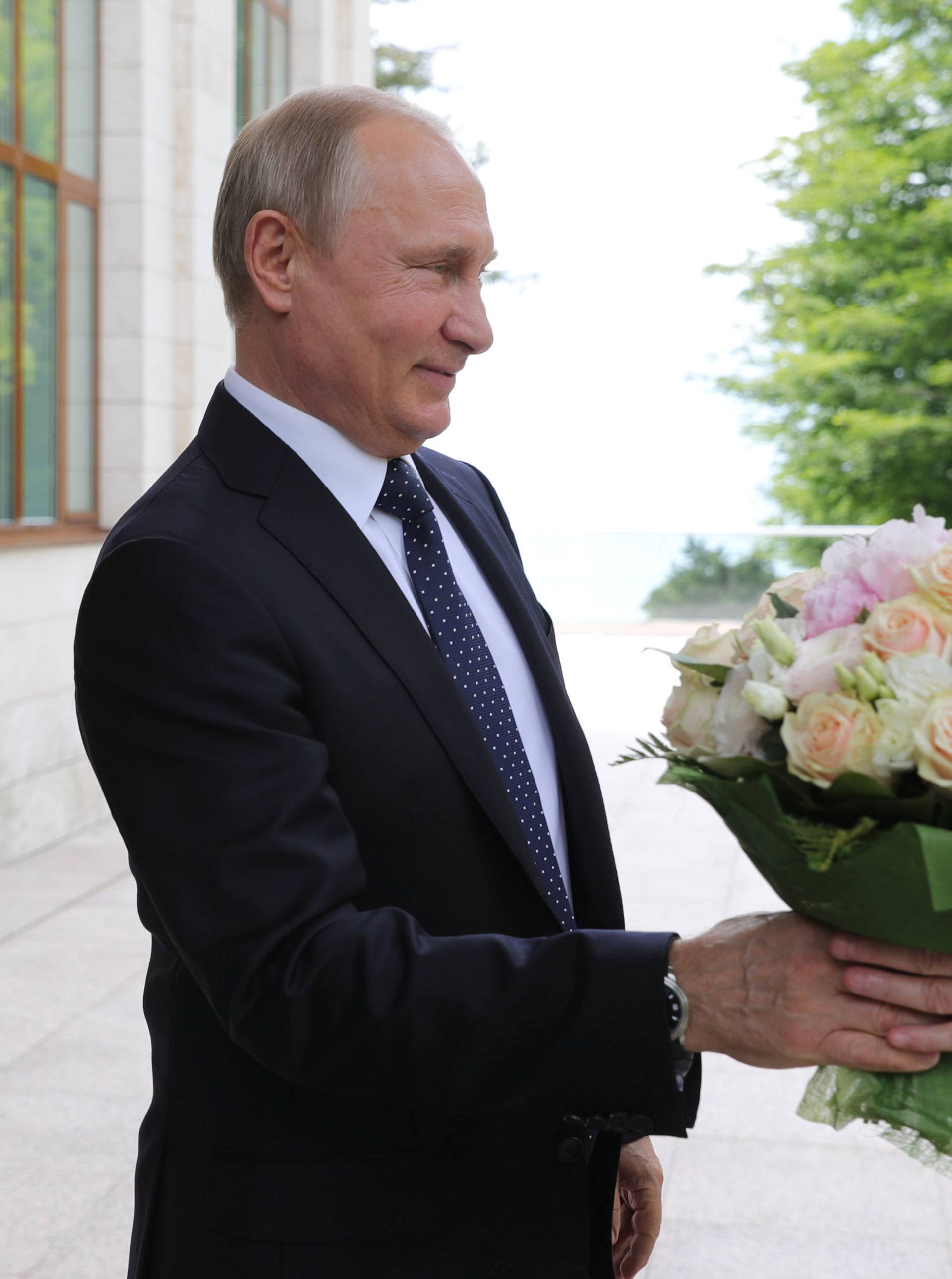 Russian President Putin welcomes German Chancellor Merkel during their meeting in Sochi