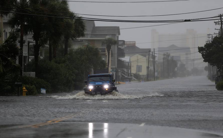 A vehicle navigates a flooded Ocean Boulevard during Hurricane Florence in North Myrtle Beach